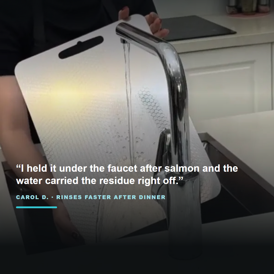 Customer rinsing a titanium cutting board under the faucet